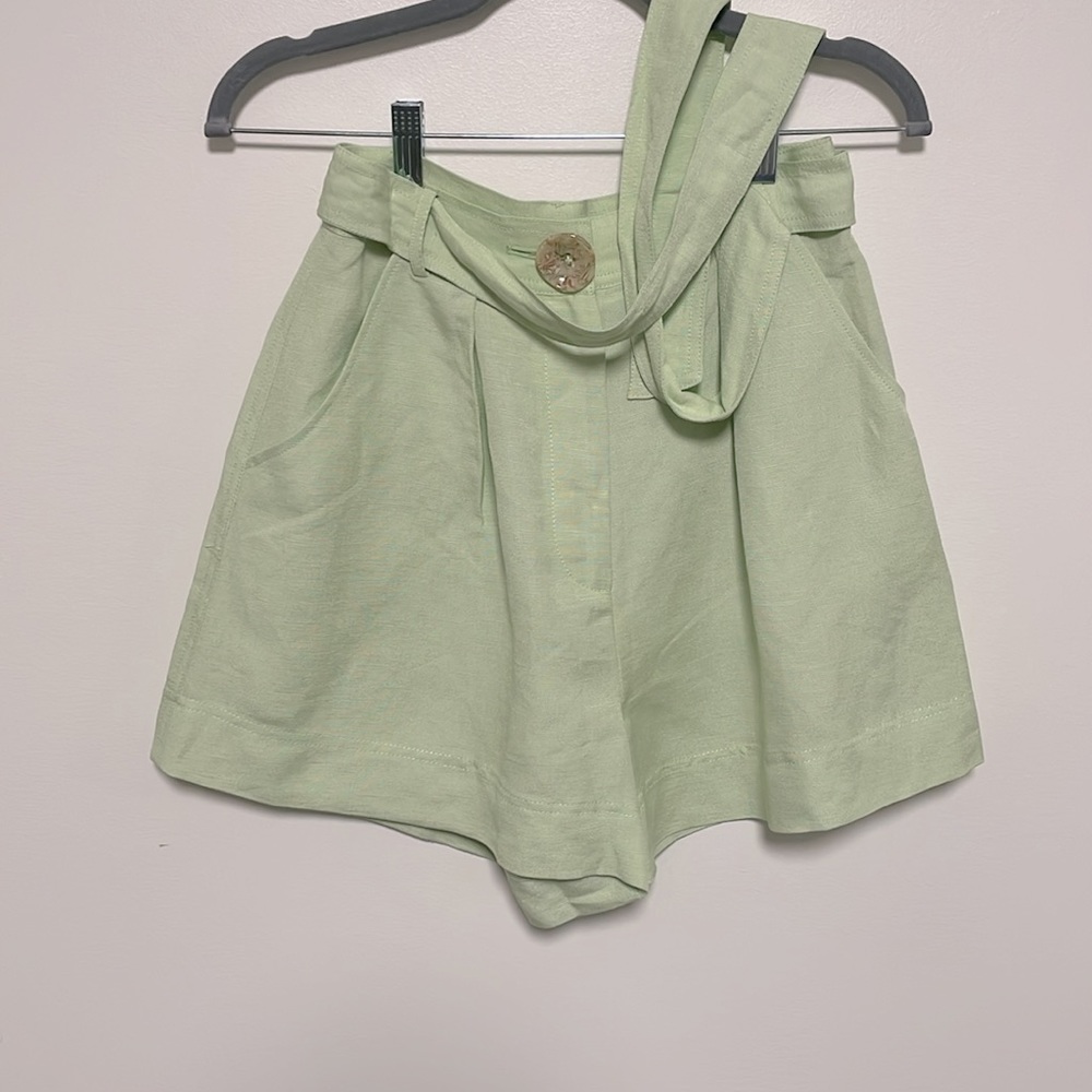 Green linen high waisted shorts with matching belt and pockets